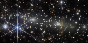 James Webb Space Telescope Captures Merging Galaxy Cluster MACS J0553.4-3342, Offering Glimpse 4.4 Billion Years into Cosmic Past